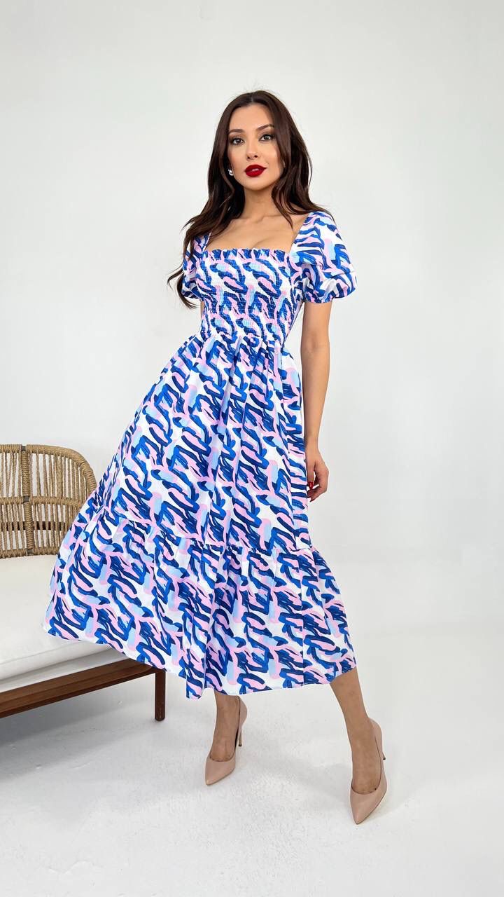 An image showcasing a white dark blue vibrant cotton summer dress with a relaxed fit and airy fabric, perfect for warm weather outings and beachside adventures