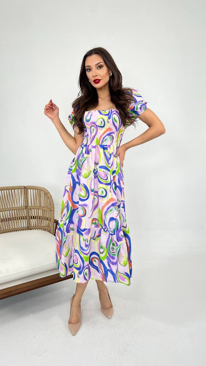 Image of a colored patterns summer cotton dress in a vibrant shade, featuring a relaxed silhouette and breathable fabric, perfect for warm weather occasions.